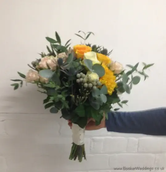 Wild Just Picked Garden Flowers with Gold, peach and Navy Bridal Hand tied Bouquet with Roses, Spray roses, Eryngium, Brunia Berries and Eucalyptus Side View