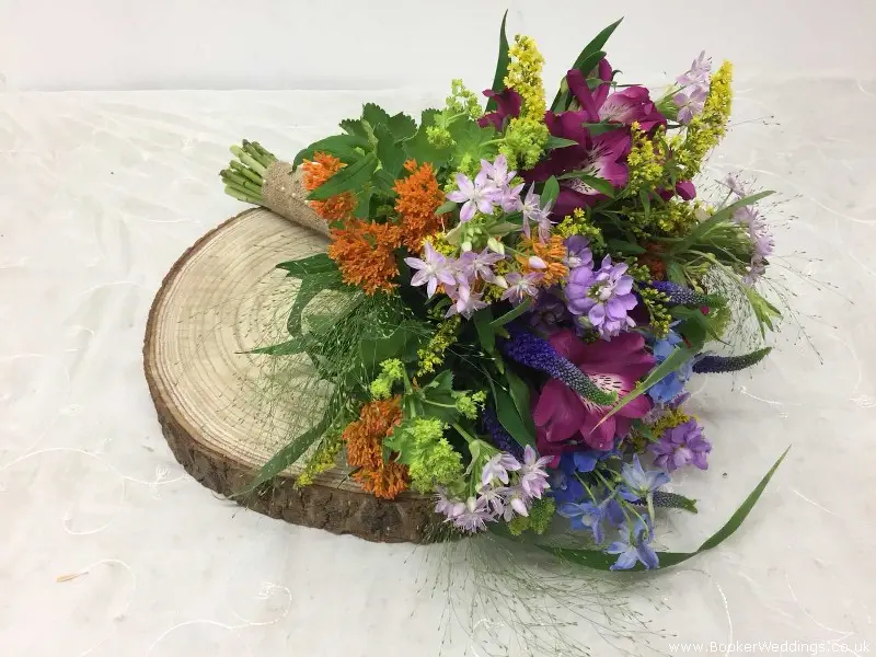 Bridesmaid Handtied Of Bright Flowers Delphinium Stocks Veronica Alstromeria  Alliums And Asclepias
