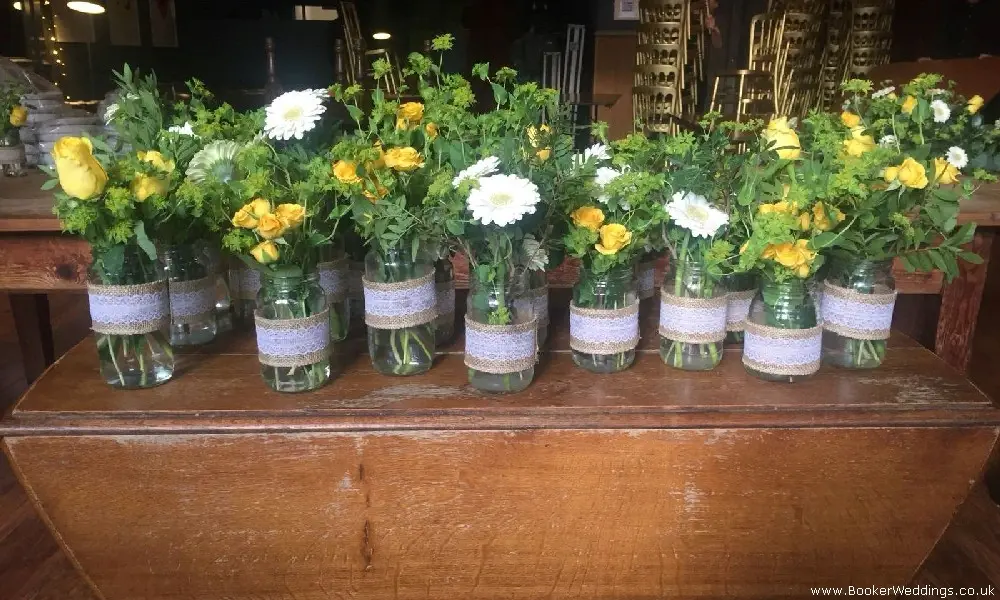 Wedding centerpieces yellow rose and white gerbera jam jars table centres