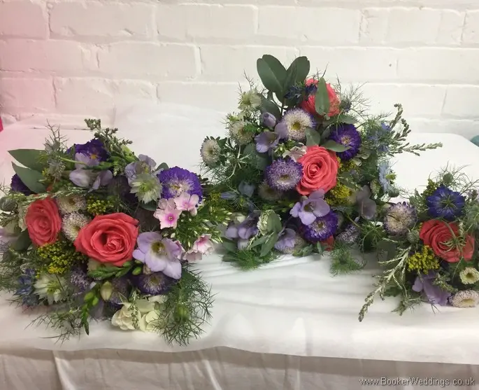 Bright and wild multicoloured bride, bridesmaid and flowergirl bouquets