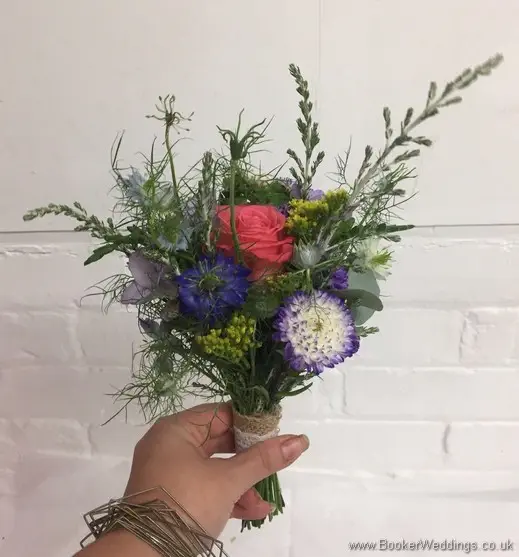 Bright just picked flowergirl bouquet in coral, pink and blue side view