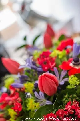 Bride hand tied bouquet in reds and blues