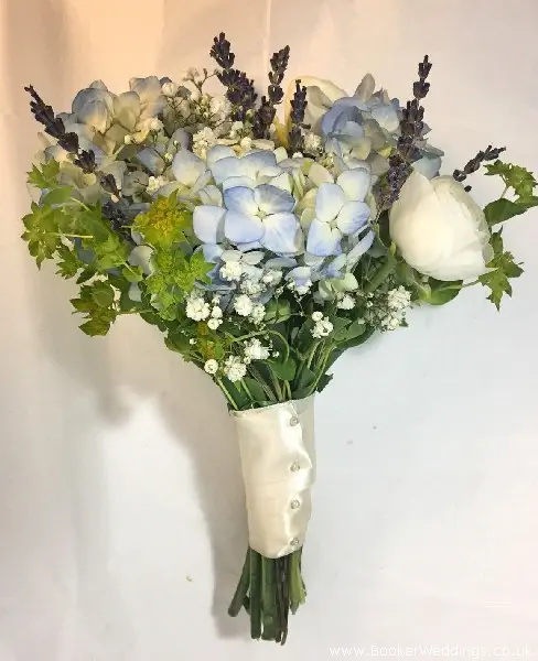 Bridesmaid hand-tied bouquet of white ranunculus, blue hydrangea, burperlum, gypsy grass and dried lavender