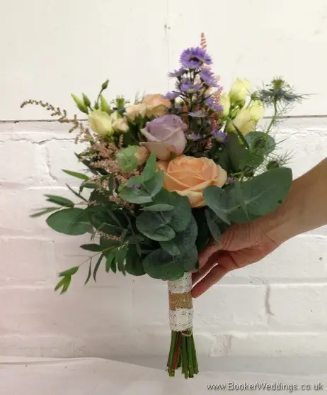 Wild Garden Hand Tied Bridesmaid Bouquet in Peach, purples and blues with roses, spray roses, astilbe, lissianthus, nigella, september flower and daisies Side