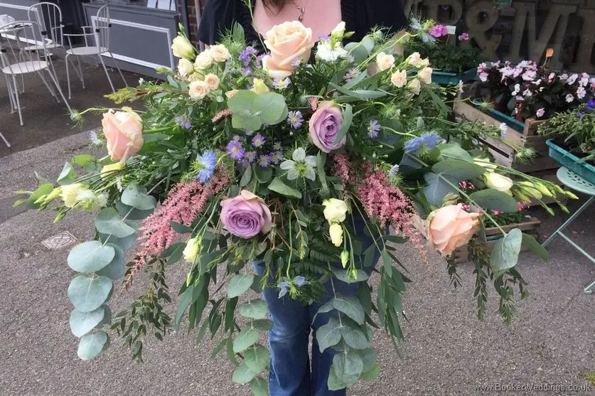 Wild Just picked garden flowers in a Long and Low Top Table Arrangement with Roses, Astilbe, Lissianthus, September flowers, Nigella and Daisies