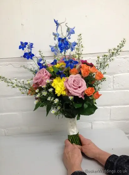 Meadow Style Bridal Bouquet with Dusky Pink Roses, Blue Delphinium, Orange Spray Roses, Cerise Gerbera, Yellow Crysanthemum and White Aster Daisy Side View