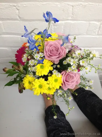 Meadow Style Multicoloured Bridal Bouquet with Dusky Pink Roses, Blue Delphinium, Orange Spray Roses, Cerise Gerbera, Yellow Crysanthemum and White Aster Daisy