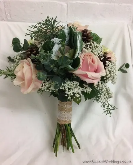 Winter wonderland bridal bouquet of blush roses ivory brassica, glitterd gypsy grass, conifer and pinecones_side view