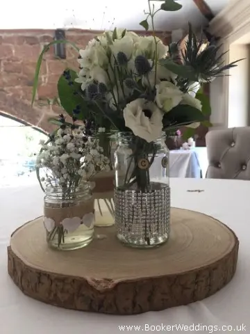 Table Centrepices Wild Flowers In Diamante Jars On Logs