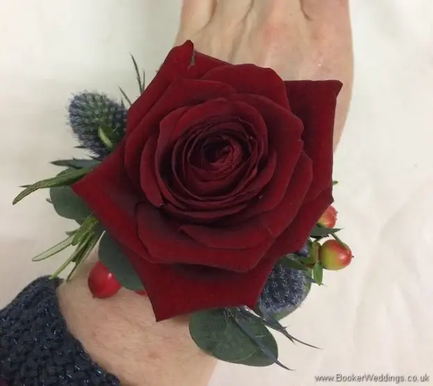 Best woman christmas wedding wrist corsage with a red rose, eryngium, winter berries and greenery_top
