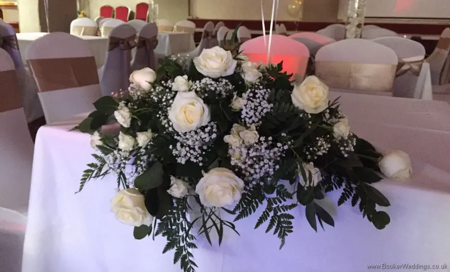 Cream rose and gypsy grass top table arrangement at The Quarry Woolton