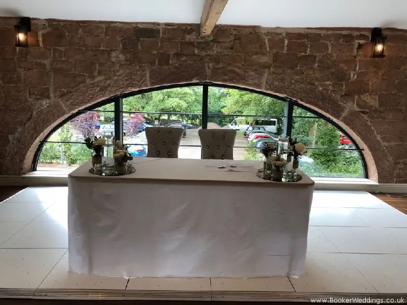 Registrar Table Flowers of Roses and Mirror Plates for Wedding Ceremony