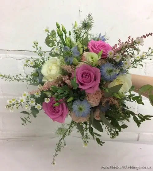 Rustic bridal bouquet in pink, cream and blue with roses, aster daisy, nigella, spray roses, astilbe, lissianthus and eucalyptus