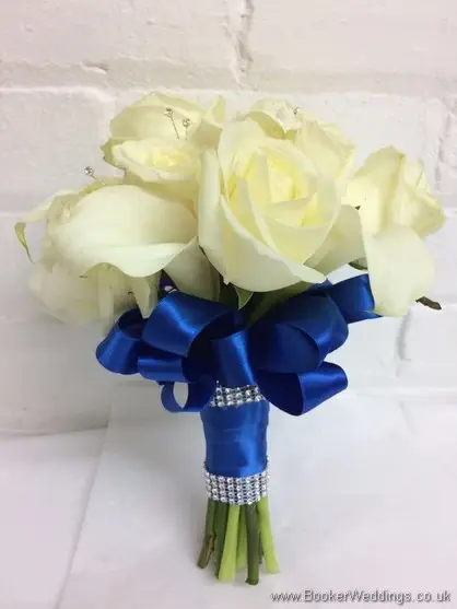 Hand tied ivory roses and calla lilies bridal bouquet with diamantes and royal blue ruffle ribbon_side view