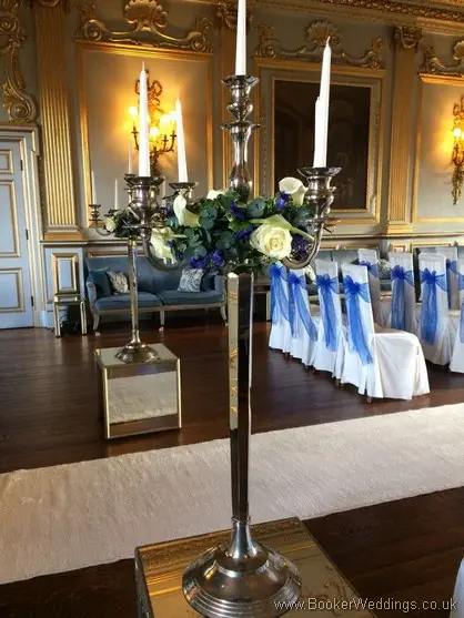 Tall Candelabra arrangments with white and blue flowers to match the wedding party at Knowsley Hall