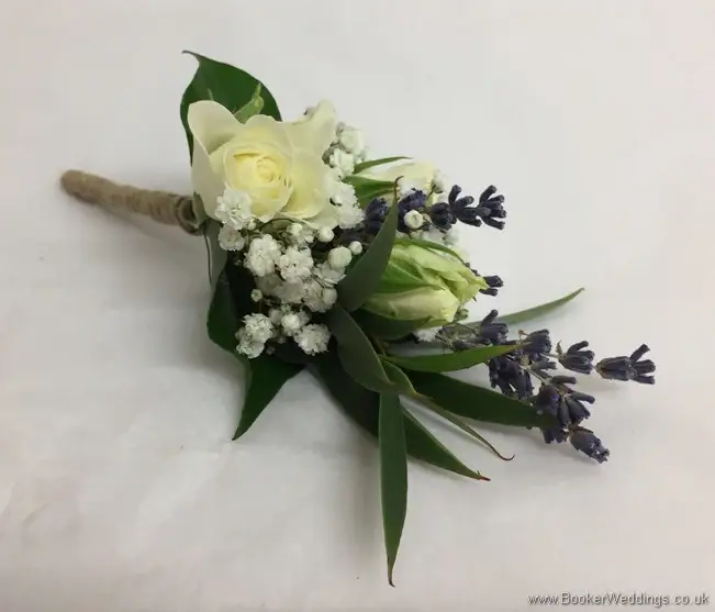 Pin corsage tied with twine with lavender, spray roses and gypsophila