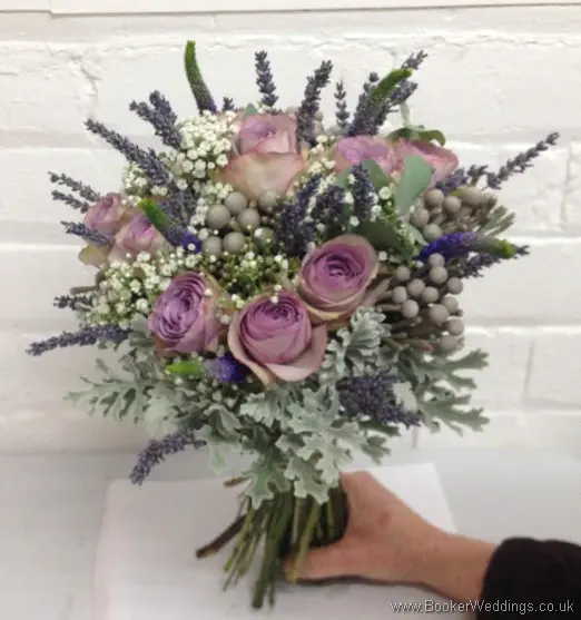 Just Picked but Neat Hand Tied Bridal Bouquet of Lilac Rose, Veronica, Gypsy Grass, Brunia Berries, Grey Senecio Leaves and Lavender tied with twine  Tilted View