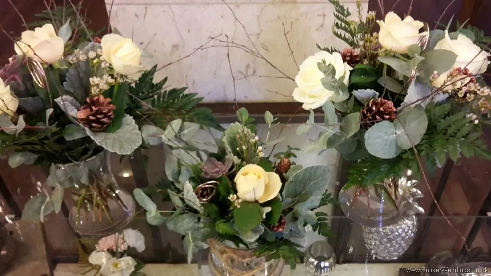 Winter woodland themed wedding Table Centrepieces with Cream avalanche & peach roses, burgundy succulents, copper cones & twigs