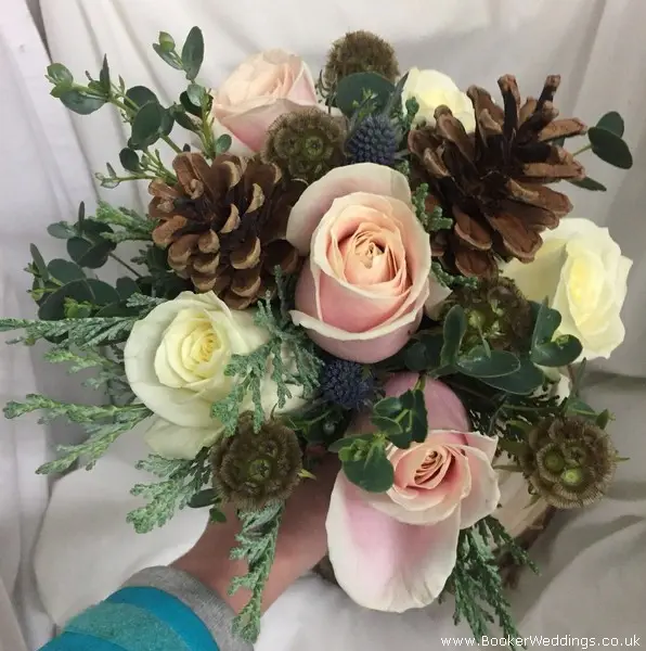 Rustic style Christmas Wedding  bridesmaid bouquet of blush and ivory roses, eryngium, scabisoa, pine cones, eucalyptus and spruce