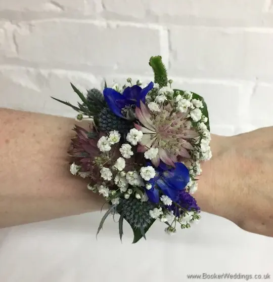 Blue and purple wild and rustic wrist corsage with eryngium, astrantia, veronica and gypsophila on wrist