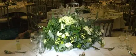 Ivory and Green Long and Low Top Table Arrangement Just Picked Wild Wedding Back View at Alicia Hotel
