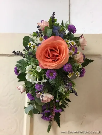 Arrangement for the back of the Bride and Grooms Chairs with rose, spray roses, aster, tanacetum, nigela, stocks, veronica and lavender front view