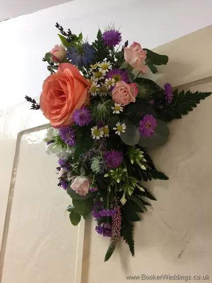 Arrangement for the back of the Bride and Grooms Chairs with rose, spray roses, aster, tanacetum, nigela, stocks, veronica and lavender side view