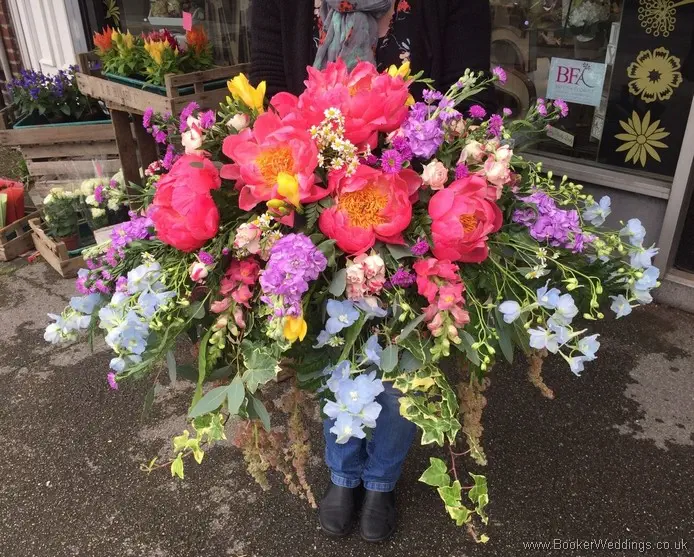 Bright Coloured Wild Country Style Top Table Arrangement with Sweetpea, freesia, Peonies, Delphinium, Stocks, Asters, Snapdragons, Tanacetum & Foliage