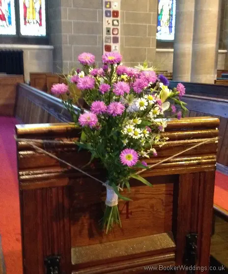 Rustic country style pew end flower arrangements inside St Barnabus Church, Liverpool