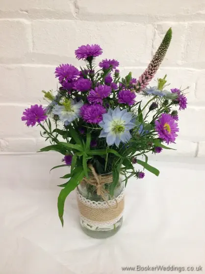 Table Centrepieces in a wild rustic country style with Aster, Veronica, Nigela