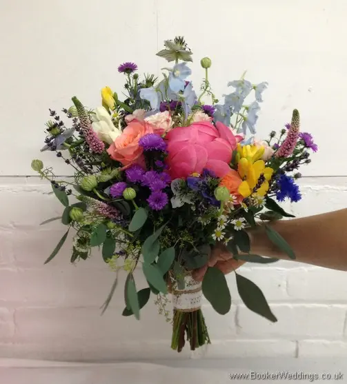 Wild just picked country bridal bouquet with Asters, Freesias, Peonies, Delphinium, Nigela, Stocks, Cornflowers, Spray Roses, Veronica, Lavender Side View