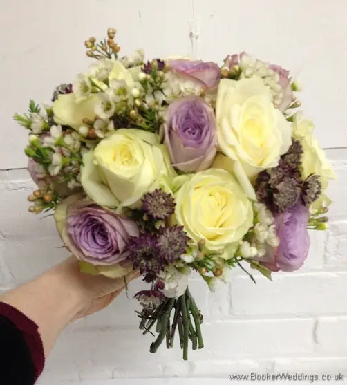Ivory & Lilac Brides Hand Tied Bouquet with cream and lilac roses, wax flowers and astrantia Tilted View