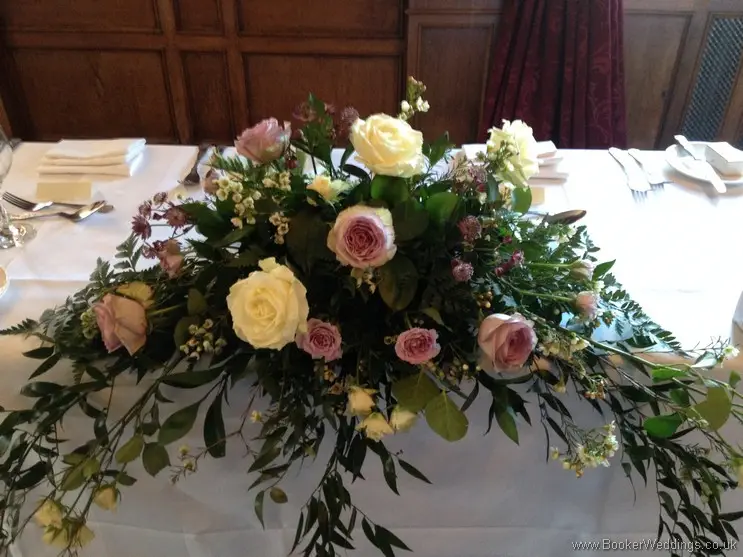 Ivory & Lilac Long and Low Top Table Arrangement with cream and lilac roses, wax flowers and astrantia at Inglewood Manor