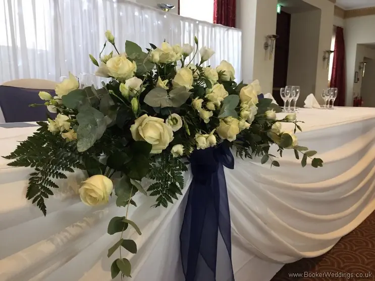 White rose, spray rose, eucalyptus and ruscus top table arrangement at Crowne Plaza Speke