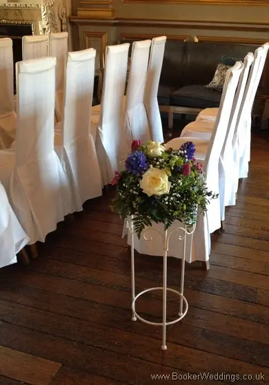 Low Pedestal Aisle Arrangements in Spring Mix Pinks Purples and Blues at Knowsley Hall