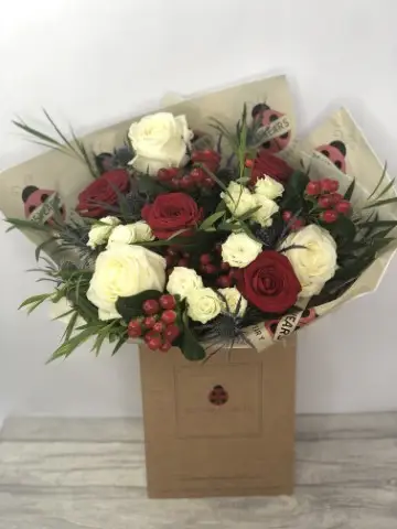 Rose Thistle and Hypericum Bouquet To Match Winter Wedding