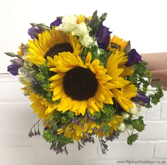 Bridal handtied bouquet with sunflowers, yellow gerberas, white spray roses, purple limoneum and purple lissianthus