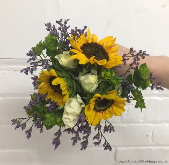 Mini Flowergirl handtied bouquet with yellow gerberas, white spray roses, purple limoneum and purple lissianthus