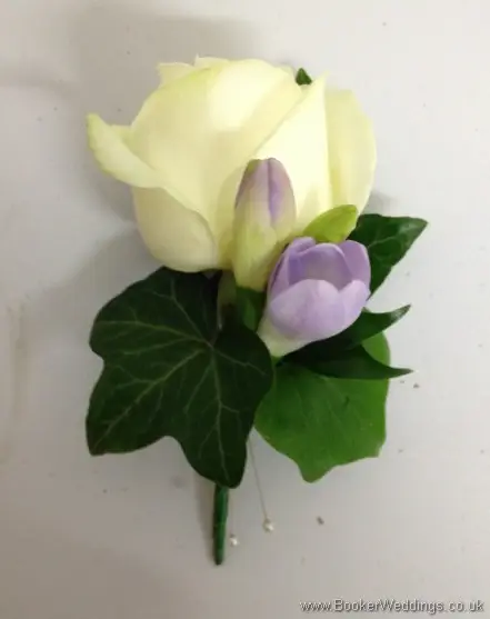 Ivory rose and lilac freesia grooms buttonhole