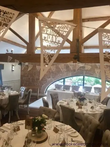Table Centrepieces of White Roses in Jars