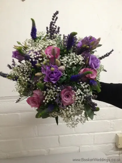 Just Picked Country Flowers in purples and lilacs with grey foliage with roses, lissianthus, veronica, gypsy grass and eucalyptus Brides Bouquet