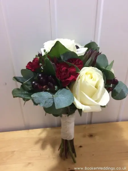 bridesmaid white rose handtied bouquet with red spray carnations hypericum berries eucadendron and foliages