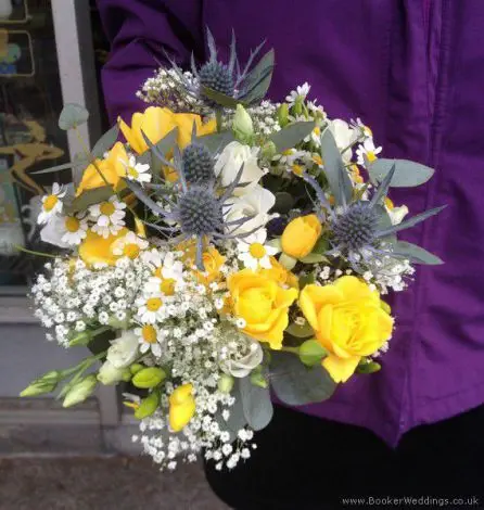 Handtied Yellow and blue bouquet with eryngium, daisy, spray rose, lisianthus and freesias