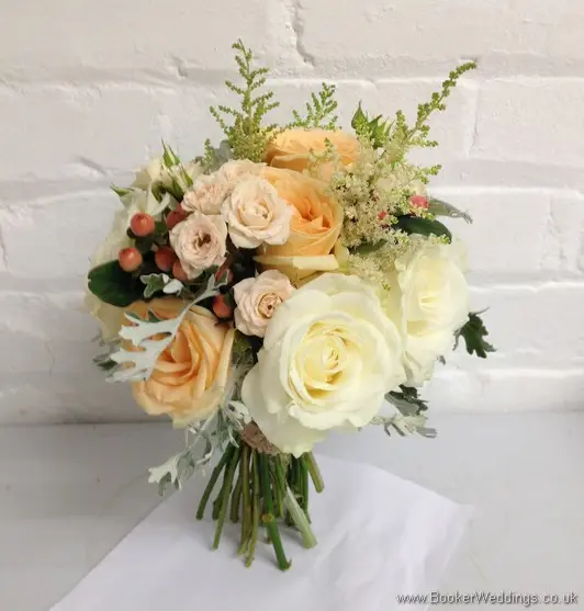 Peaches & Cream Wild Country Garden Bridal Bouquet with roses, spray roses, astilbe, hypernicum berries & grey senicio leaves Side View