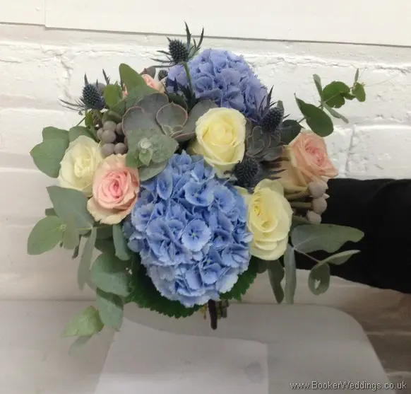Wild Just Picked Blue, Cream & Blush Pink Bridal Bouquet with roses, hydrangea, eryngium, grey succulents and eucalyptus tilted view