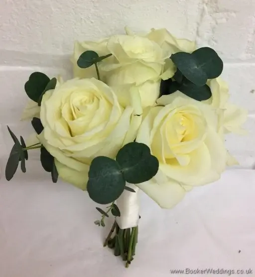 Hand tied bridesmaid bouquet with ivory roses and greenery_tilted