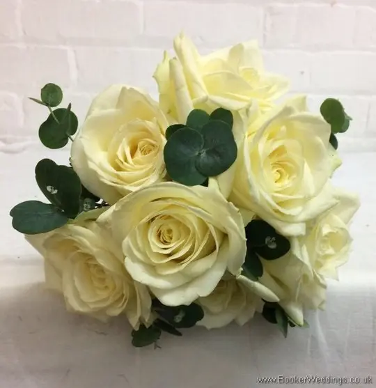 Hand tied bridesmaid bouquet with ivory roses and greenery_top