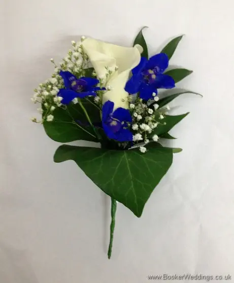 Blue and White Grooms Buttonhole featuring white calla lilies, blue delphinium and gypsy Grass
