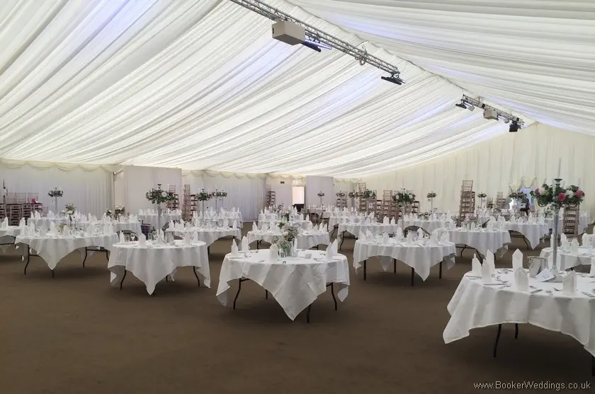 Mixed Tall Table Arrangements and low jars of flowers on tables at the Vets Ball in Thornton Manor Marquee